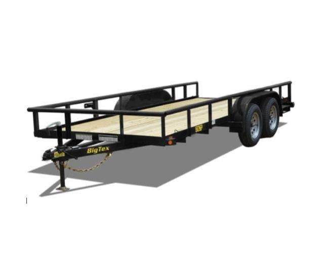 A couple of trailers are parked in front of a house