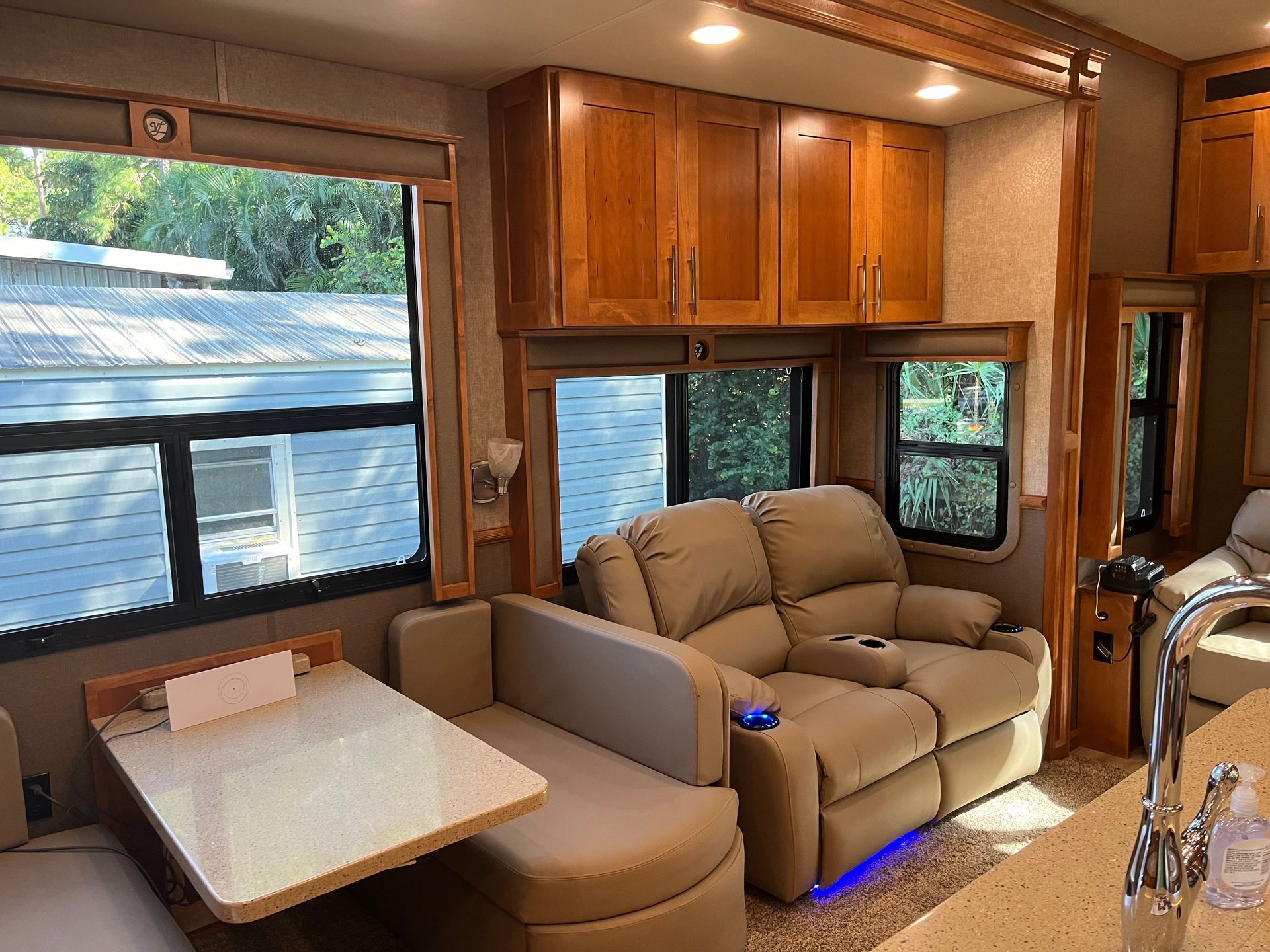 A living room in a rv with a couch and a table.