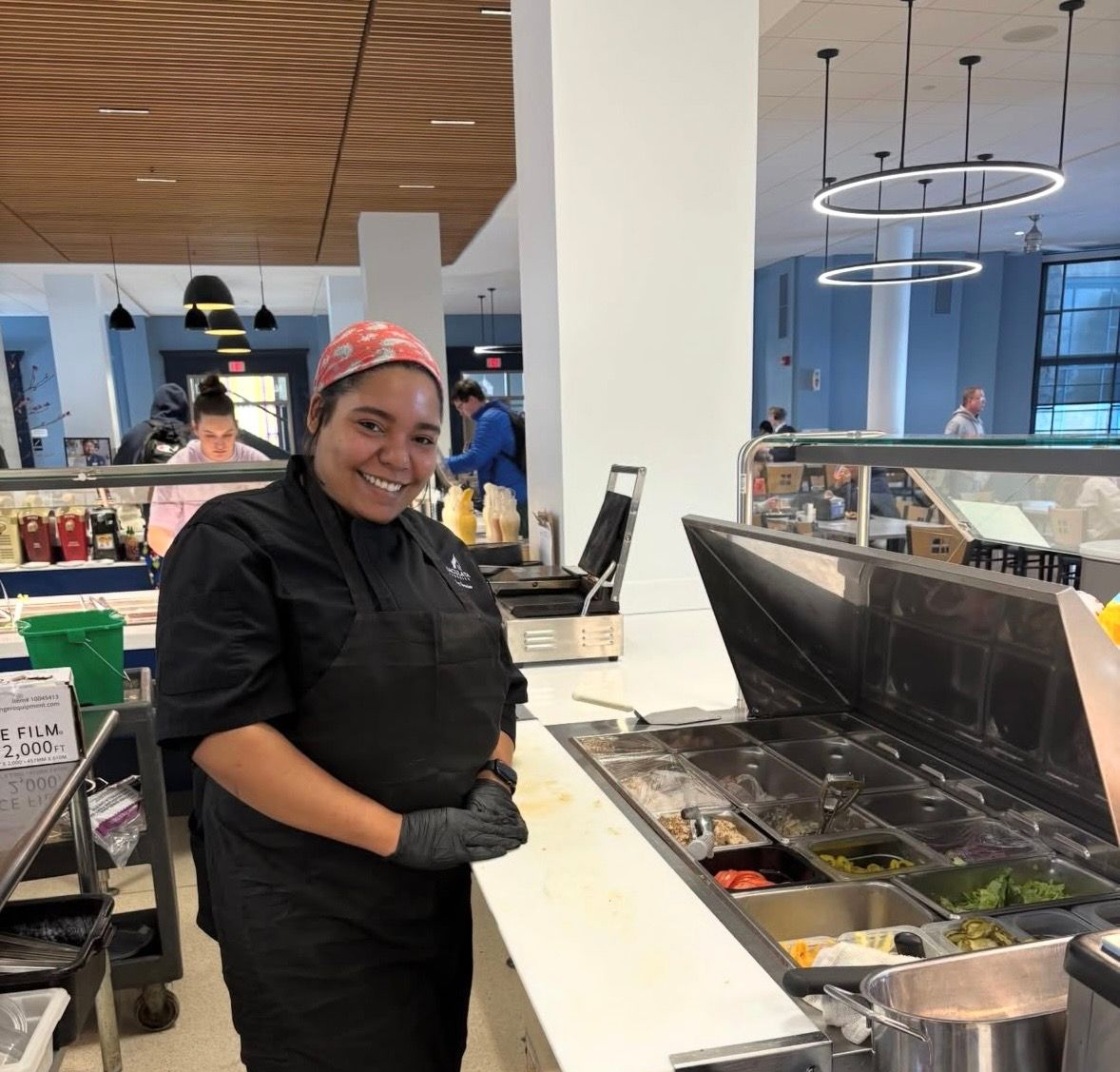 Cookie with building logo in front of a blurred building with a green dome and a blue sky.