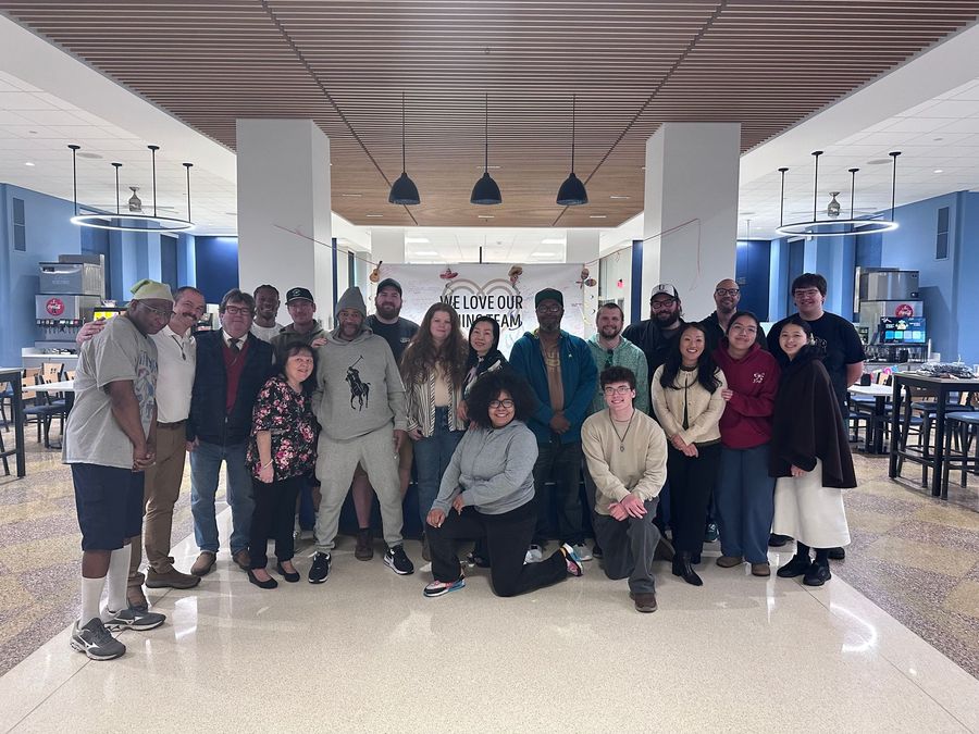 Cookie with building logo in front of a blurred building with a green dome and blue sky.
