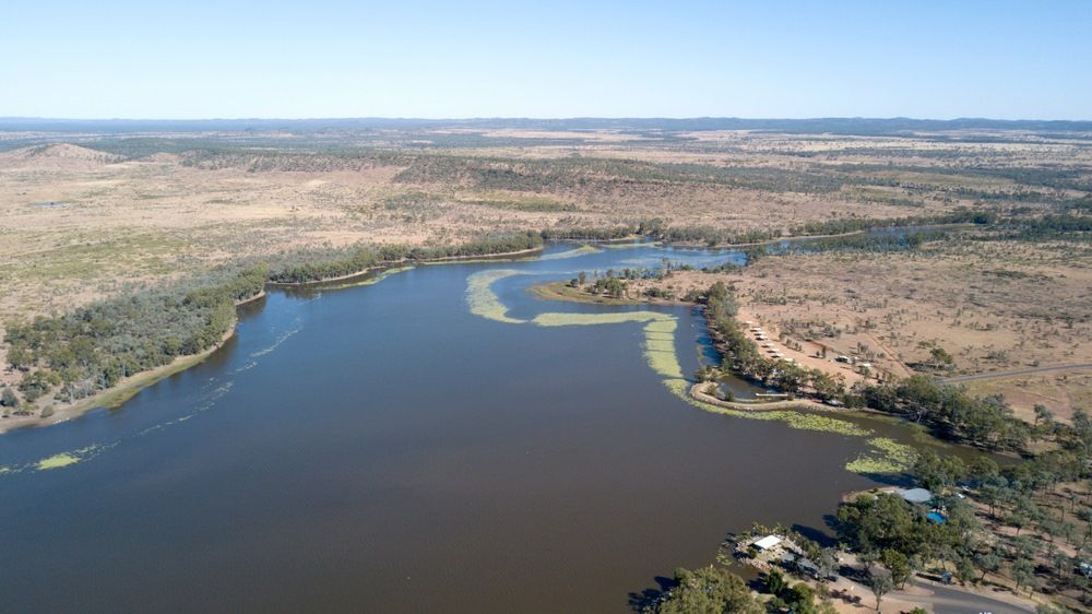 An Aerial View of a Large Body of Water Surrounded by Trees — Statewide Lift & Shift Pty Ltd In Clermont, QLD