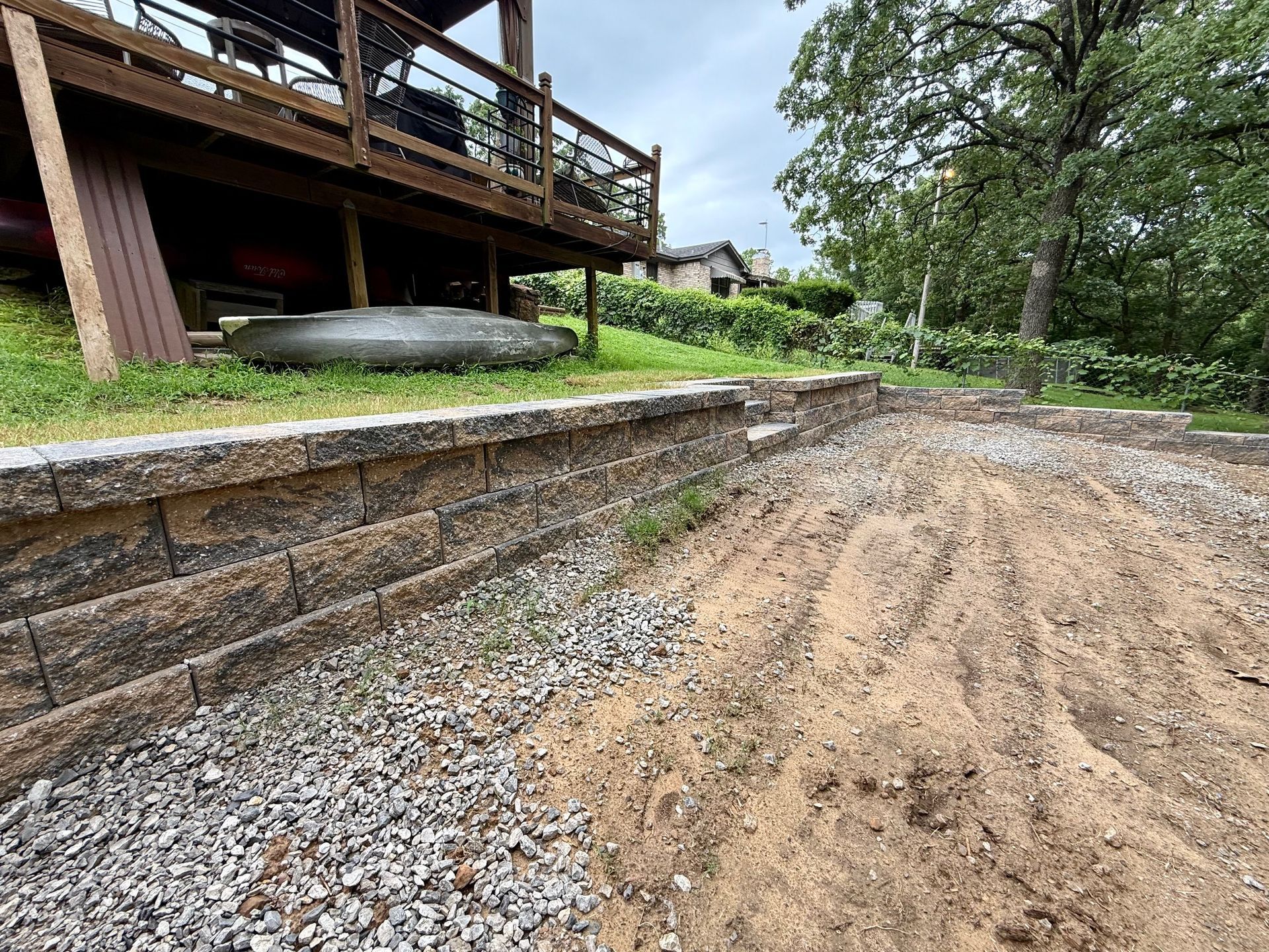 Concrete steps leading down, surrounded by brown mulch.