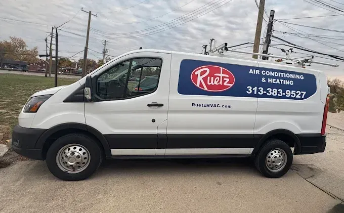 White van with Ruetz Air Conditioning & Heating logo, parked outdoors. Phone number is visible.