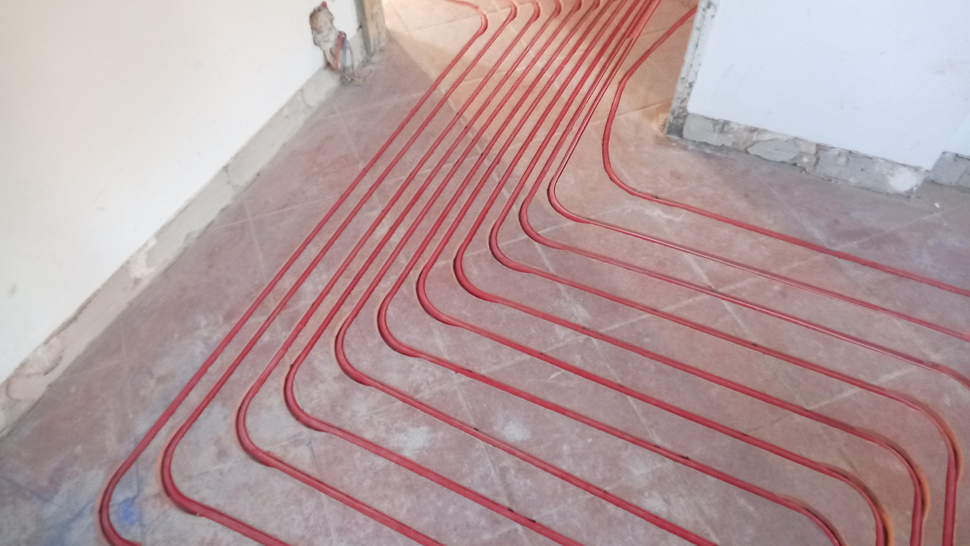 Goodman furnace in a utility room next to a water heater and washing machine.