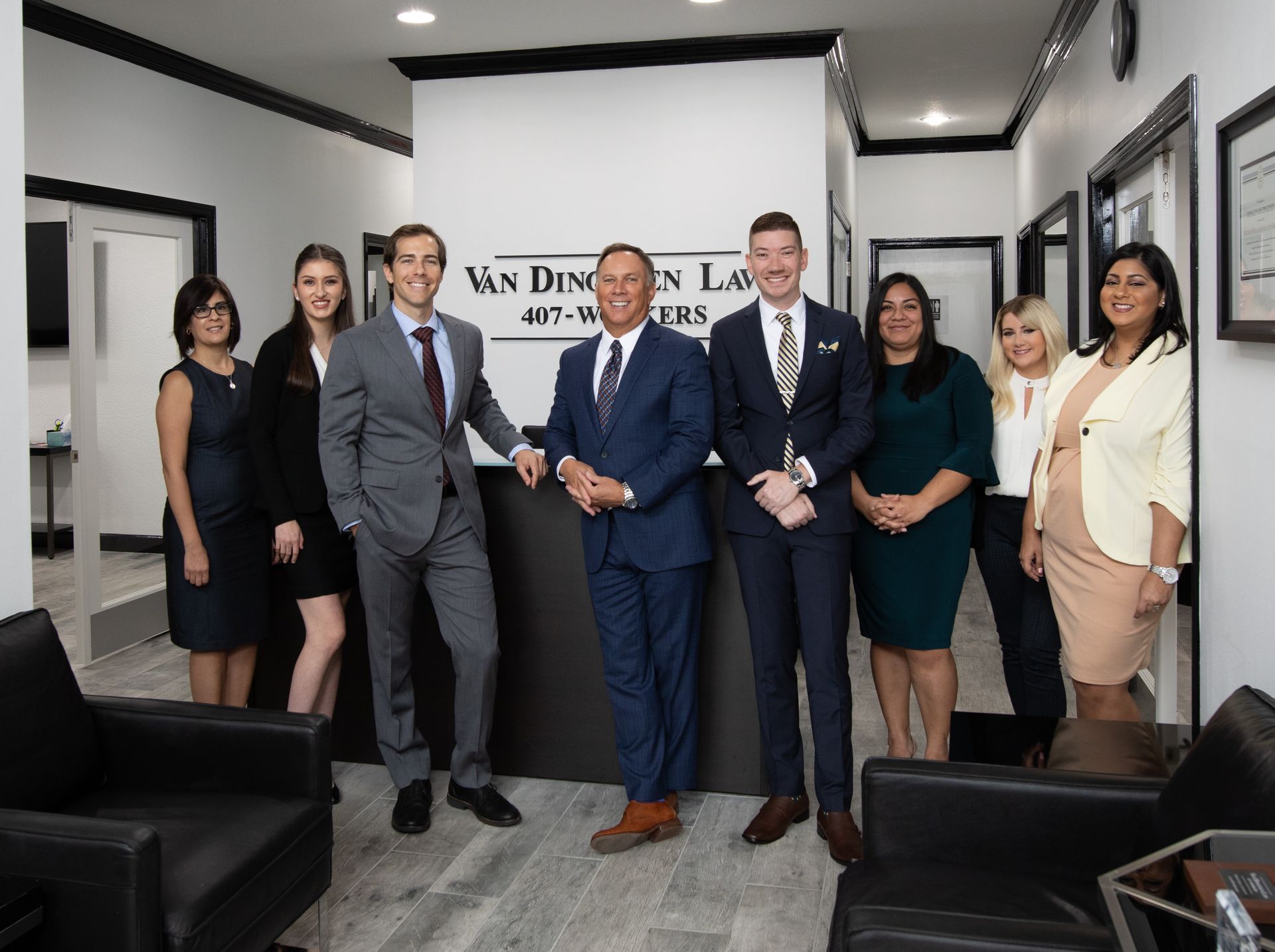 Two men are standing in a kitchen holding rolling pins.