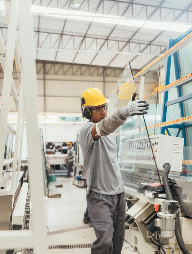 A man is working on a machine in a factory.