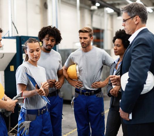 A man is working on a machine in a factory.