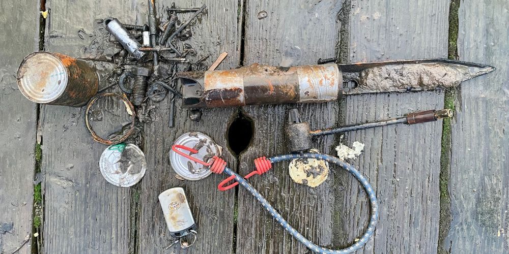 A bunch of tools are laying on a wooden table.