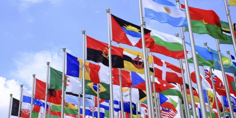 A bunch of flags are waving in the wind
