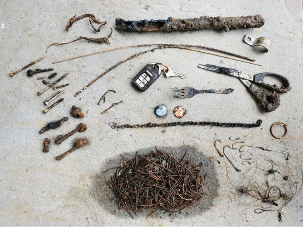 magnet fishing treasure including a sword and scissors