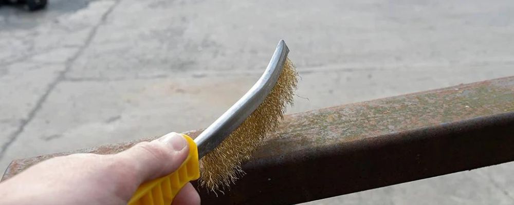 removing rust with a wire brush