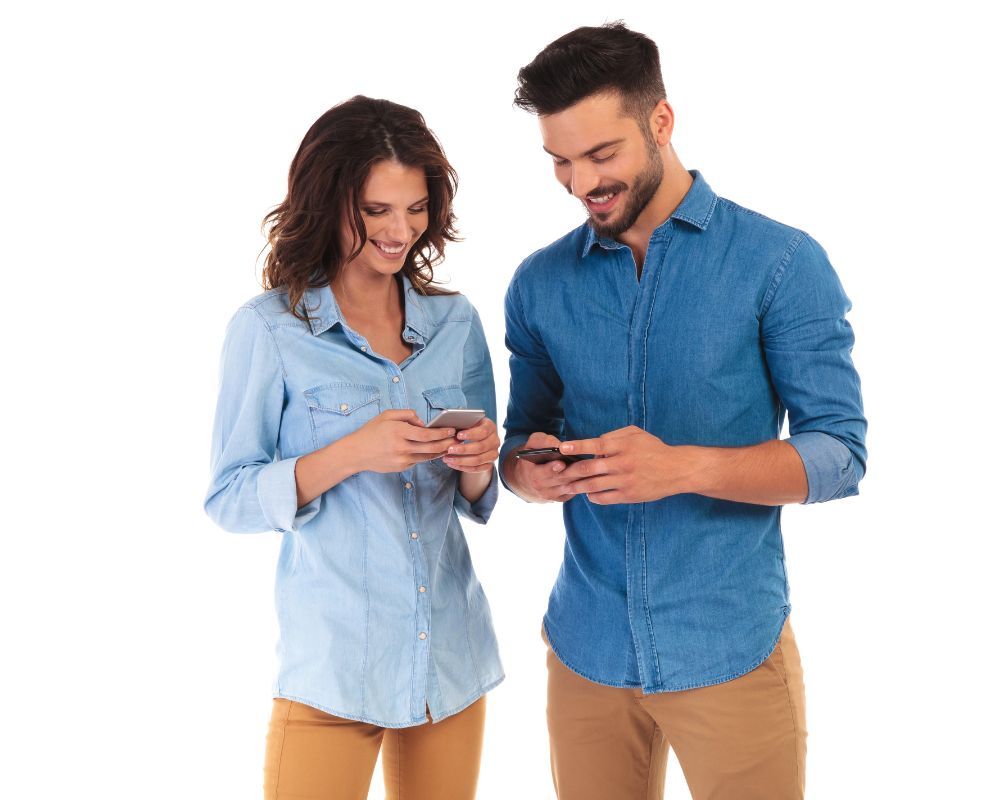couple using phones on white background