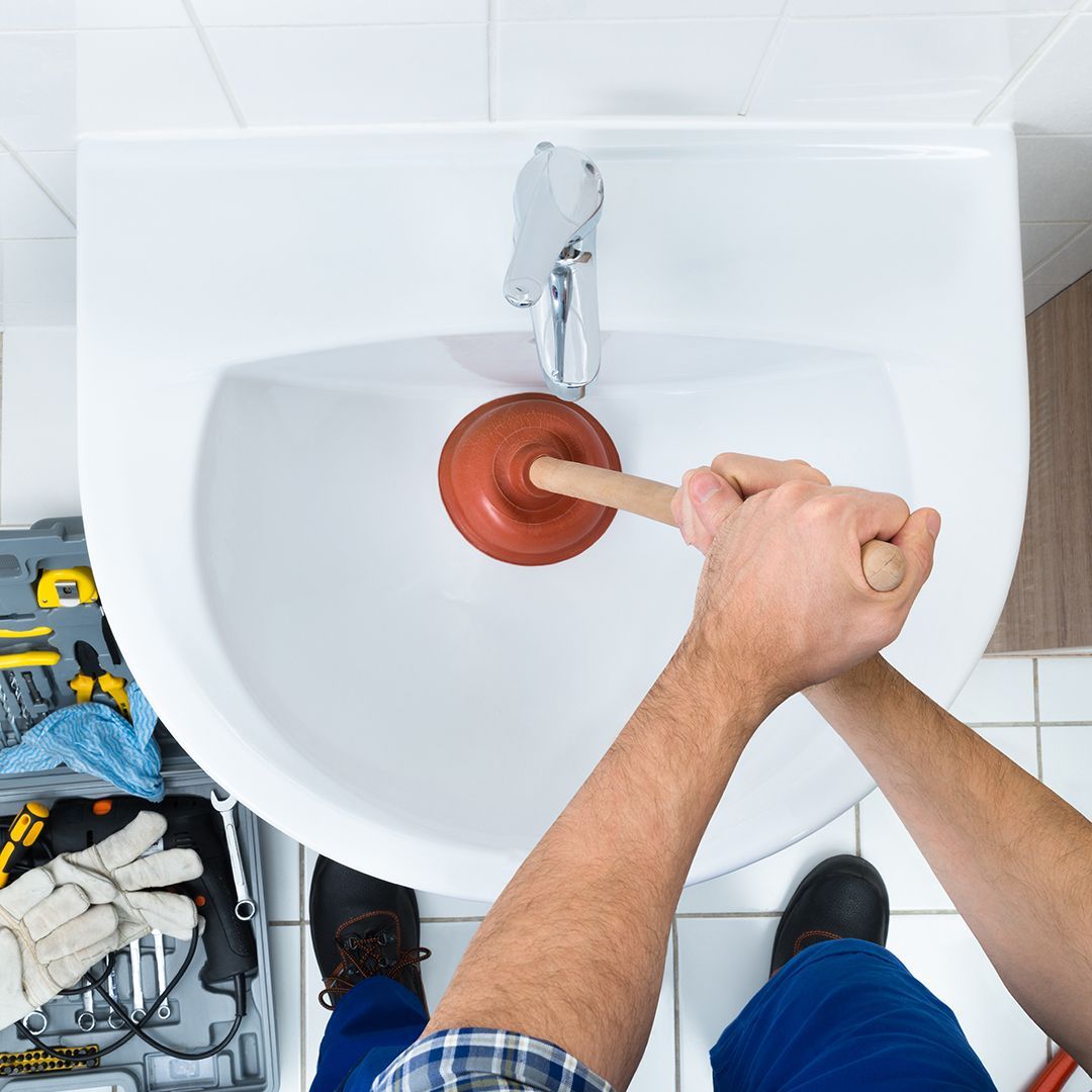A person’s hands holding a smartphone in a bright, modern office. The phone screen shows a clean financial dashboard with upward-trending growth charts and organized data. Stock image style.