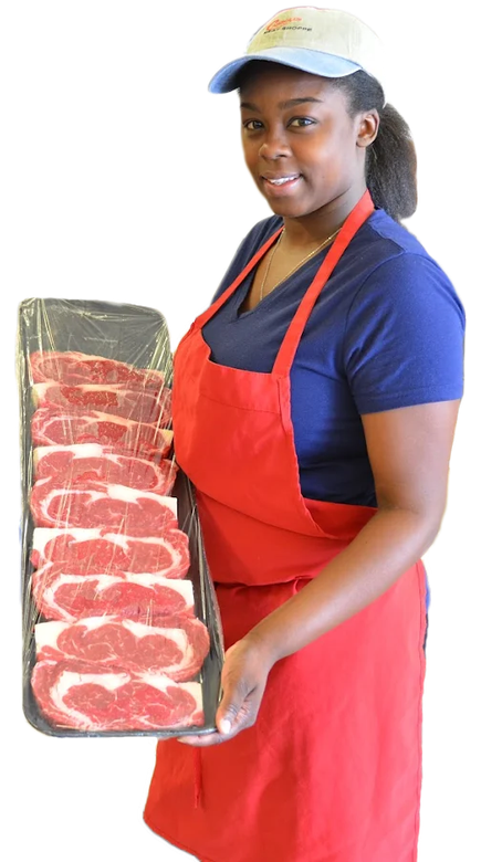 Butcher in red apron holding a tray of sliced raw meat under a white cap