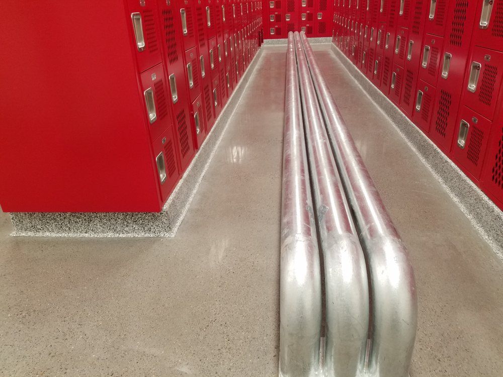A row of red lockers in a school locker room