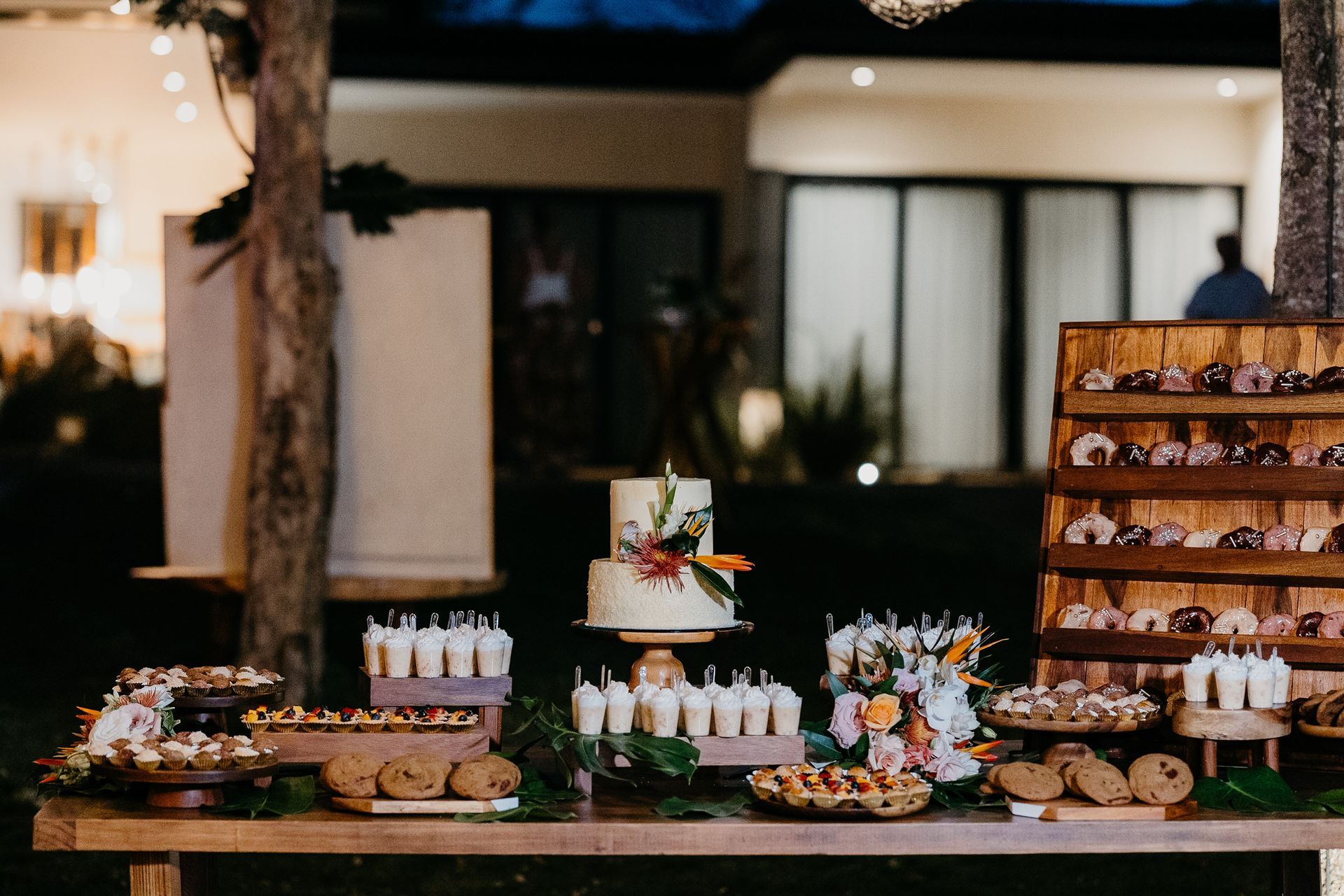 A dessert table with a cake and cupcakes on it.