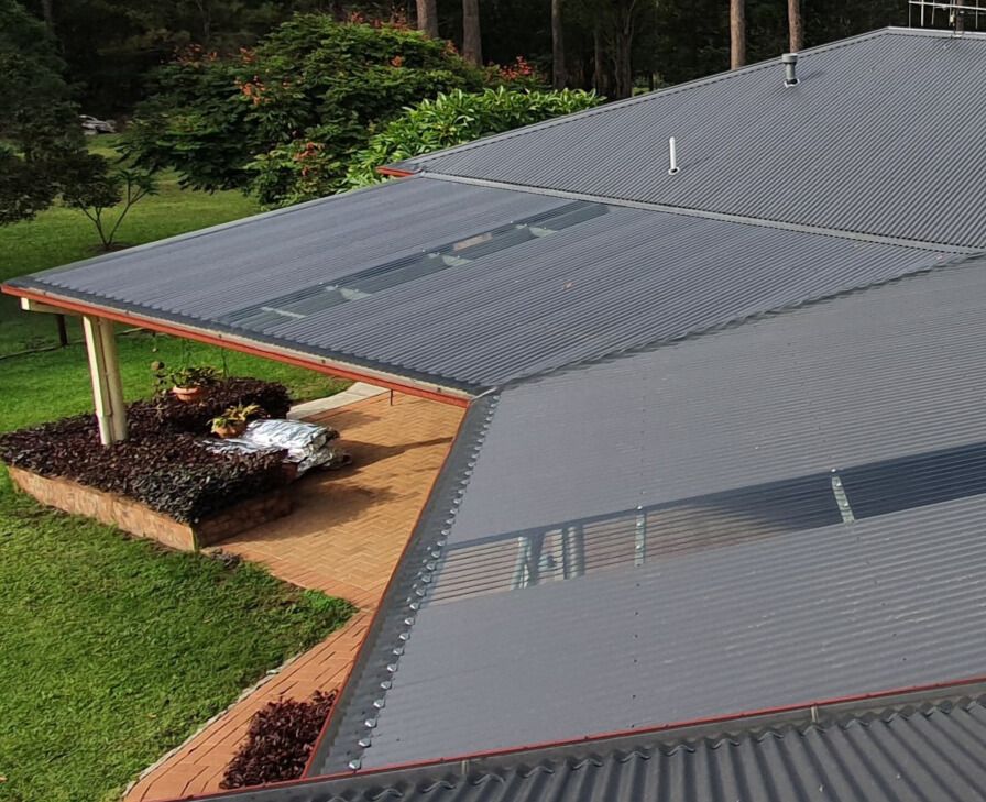 A close up of a gutter guard on the roof of a house — Glenroofing Pty Ltd In Taree, NSW