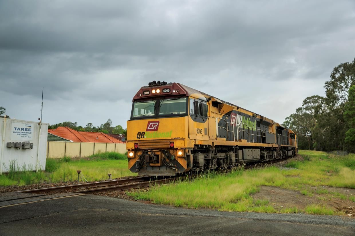 A Train Is Going Down The Tracks On A Cloudy Day — Glenroofing Pty Ltd In Taree, NSW