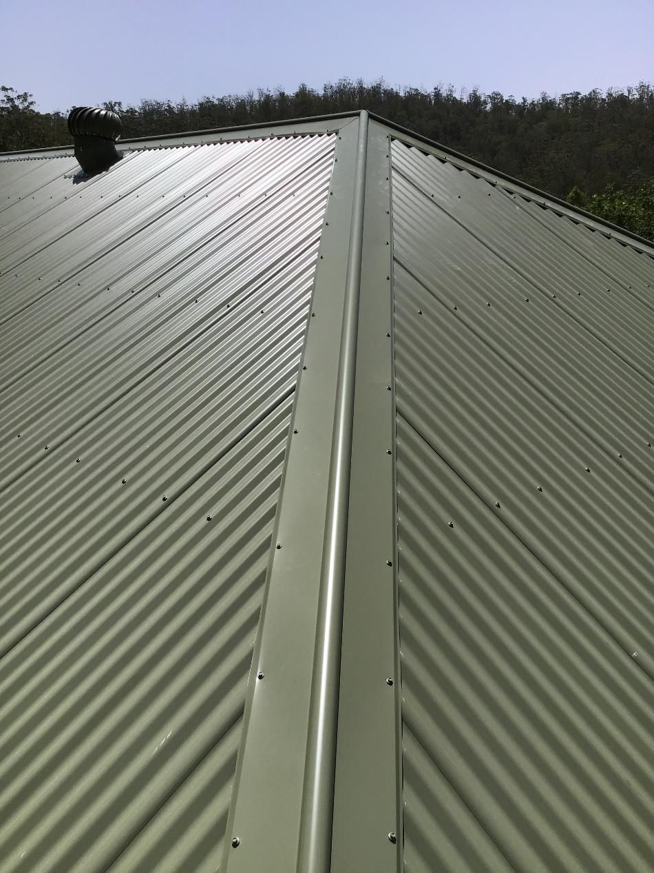 A Green Roof With A Chimney On Top Of It — Glenroofing Pty Ltd In Taree, NSW