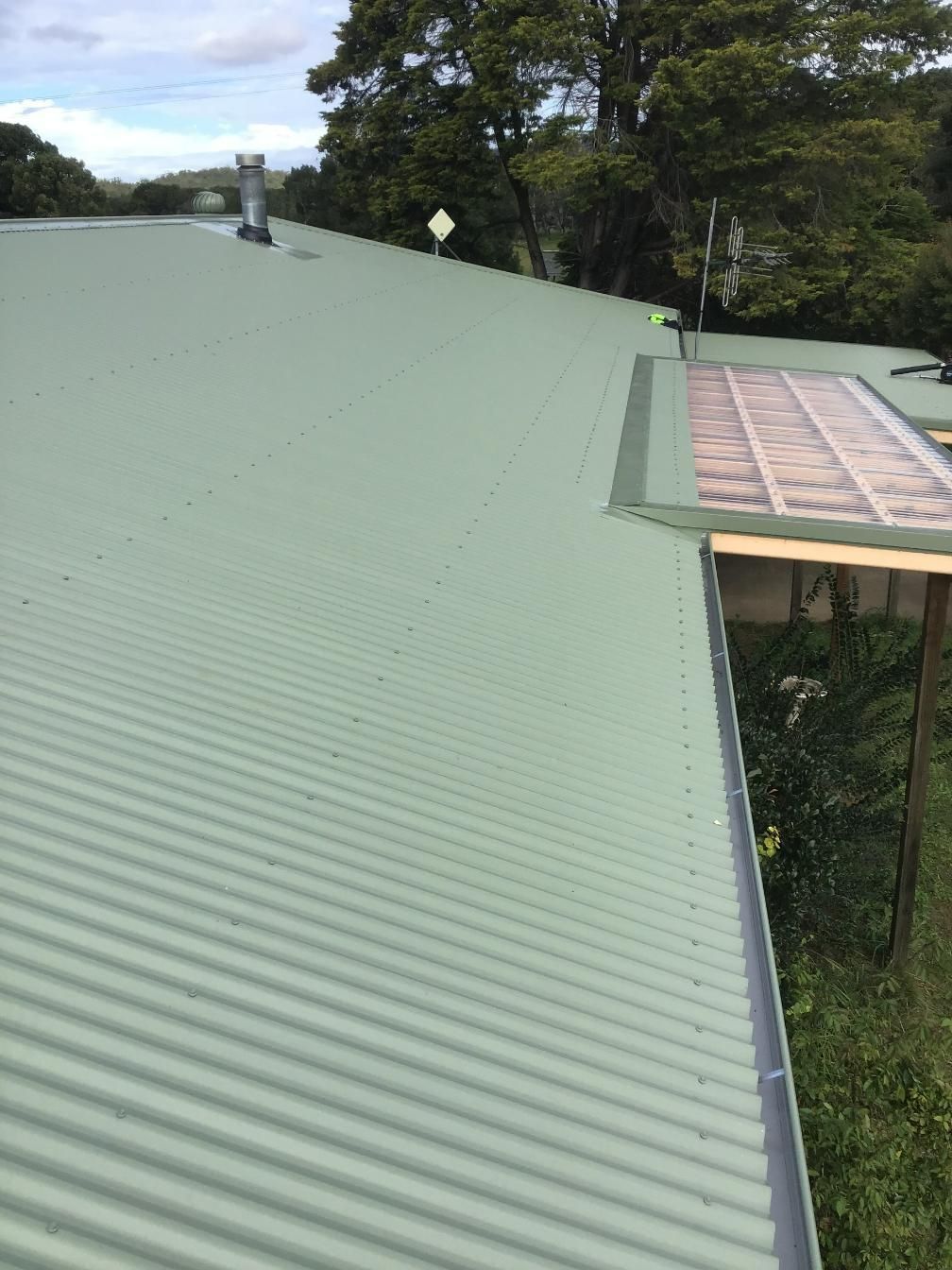 A Green Corrugated Metal Roof With A Gutter On The Side Of It — Glenroofing Pty Ltd In Kempsey, NSW