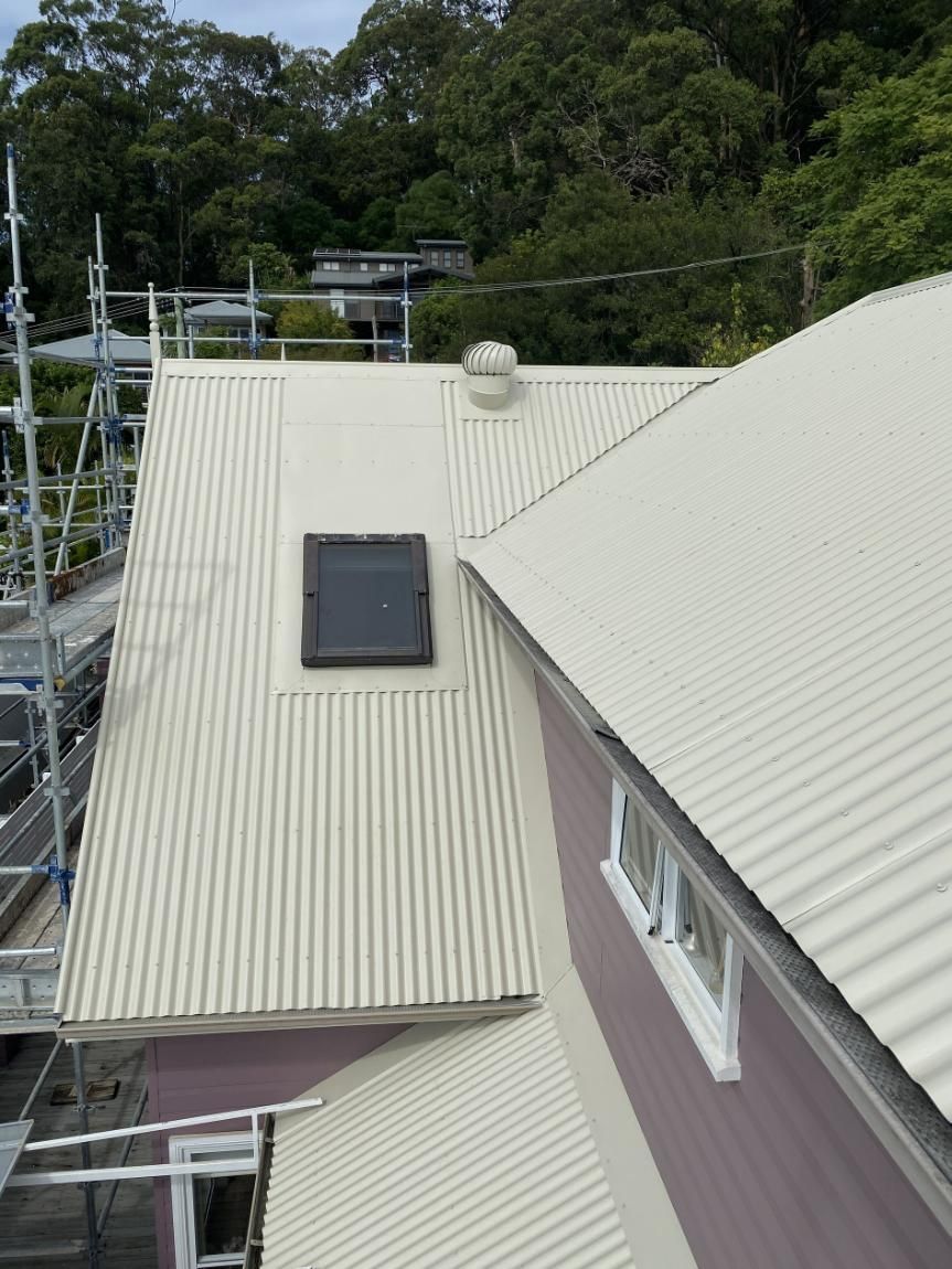 A White Corrugated Metal Roof With A Skylight On Top Of It — Glenroofing Pty Ltd In Taree, NSW
