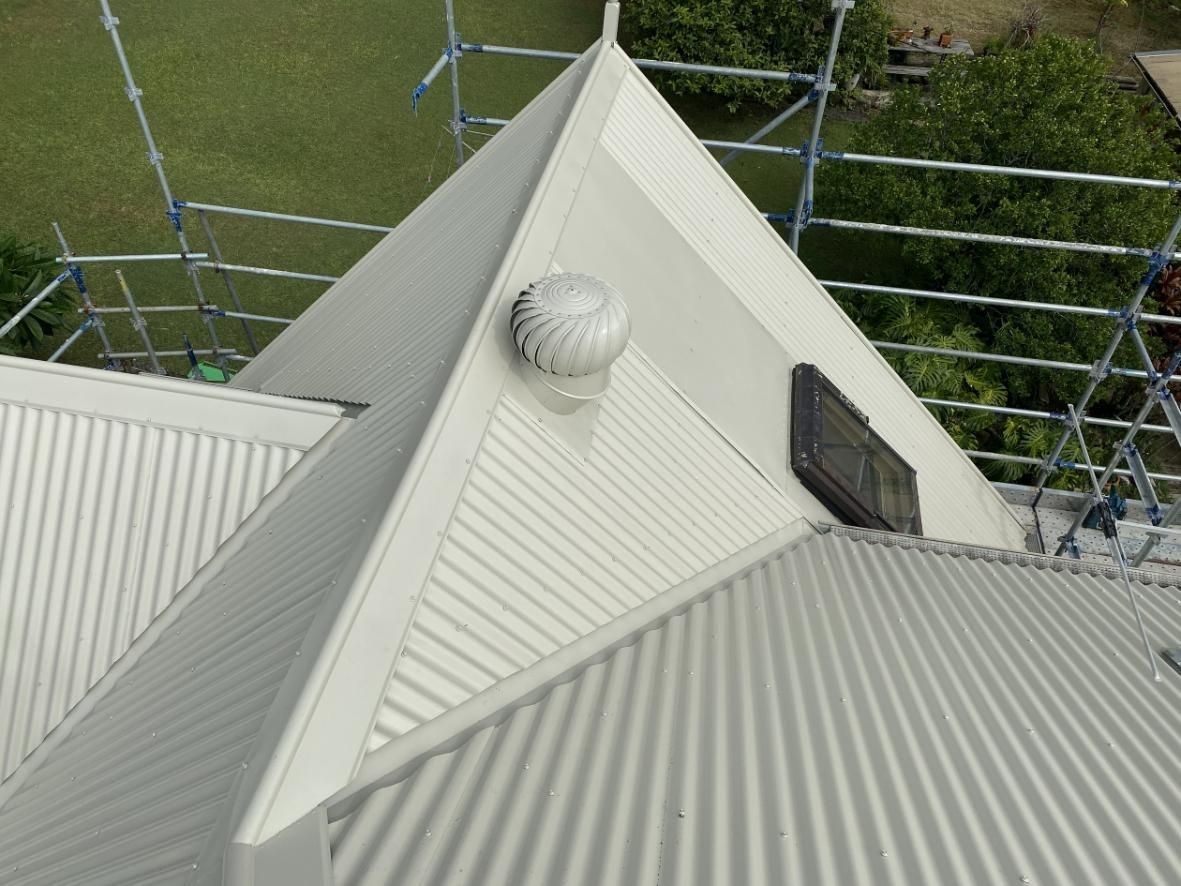 An Aerial View Of A White Roof With Scaffolding In The Background — Glenroofing Pty Ltd In Gloucester, NSW