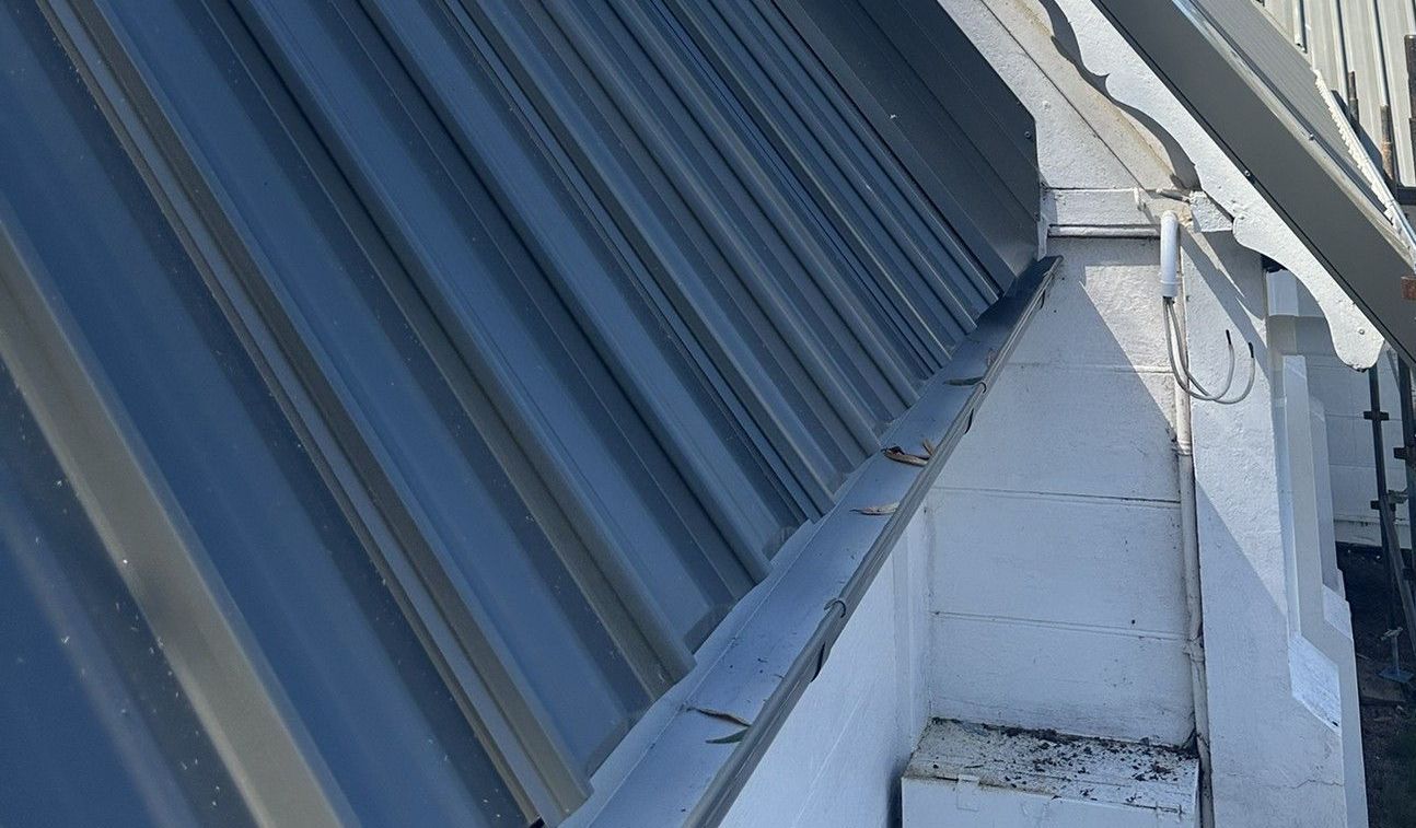 A Close Up Of A Gutter On A Red Roof — Glenroofing Pty Ltd In Taree, NSW