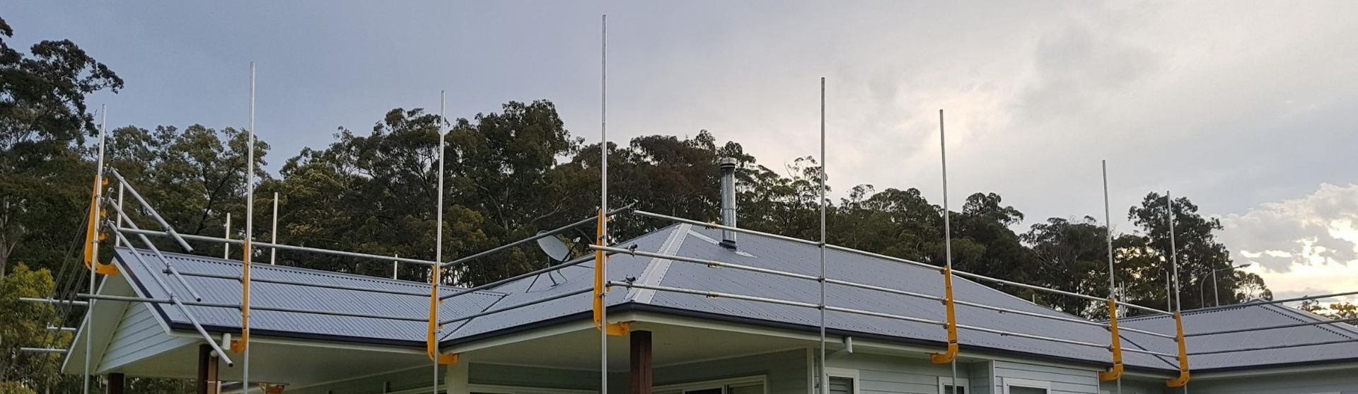 A House Is Being Built With Scaffolding On The Roof — Glenroofing Pty Ltd In Newcastle, NSW