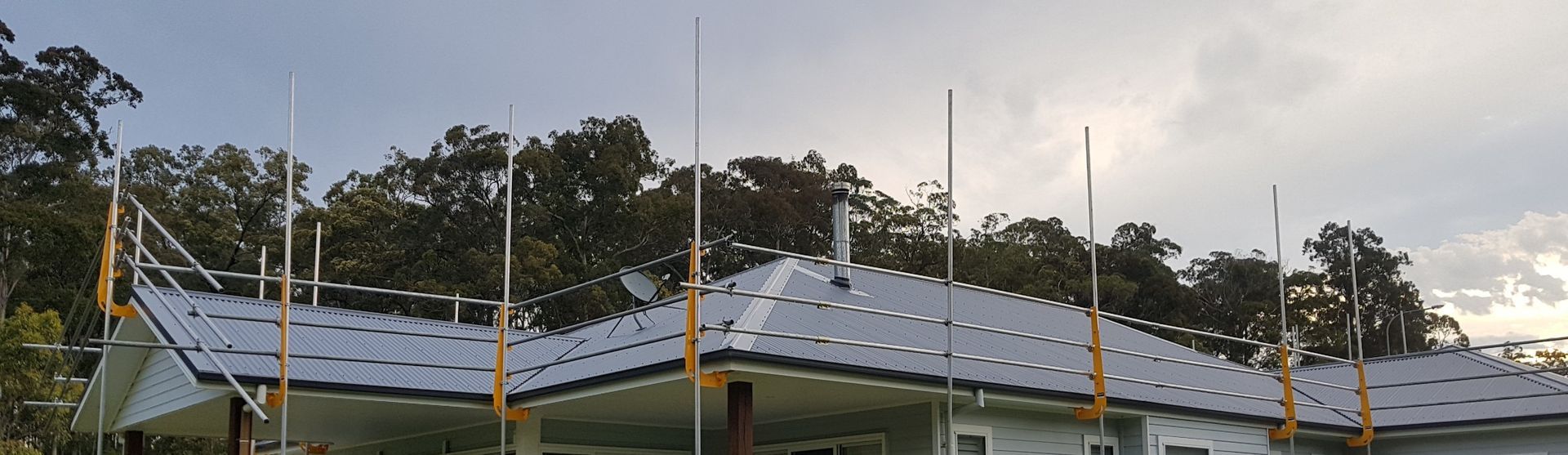 There Is A Gutter On The Side Of A Wooden Building — Glenroofing Pty Ltd In Taree, NSW