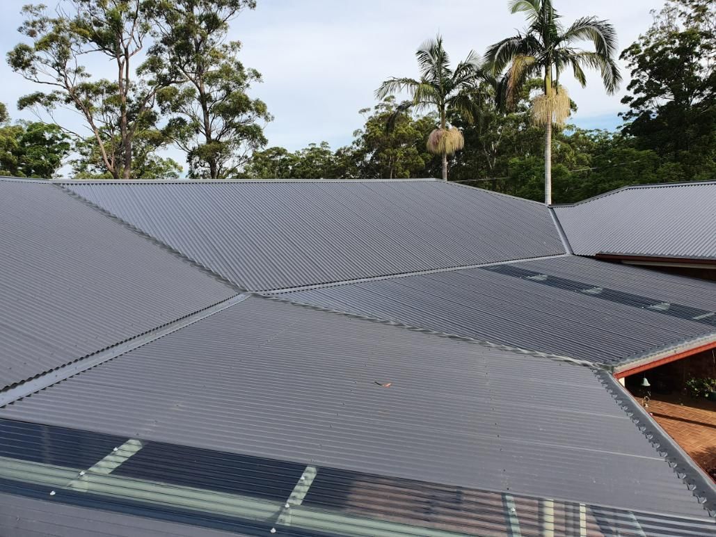 A Close Up Of A Roof With Trees In The Background — Glenroofing Pty Ltd In Coffs Harbour, NSW