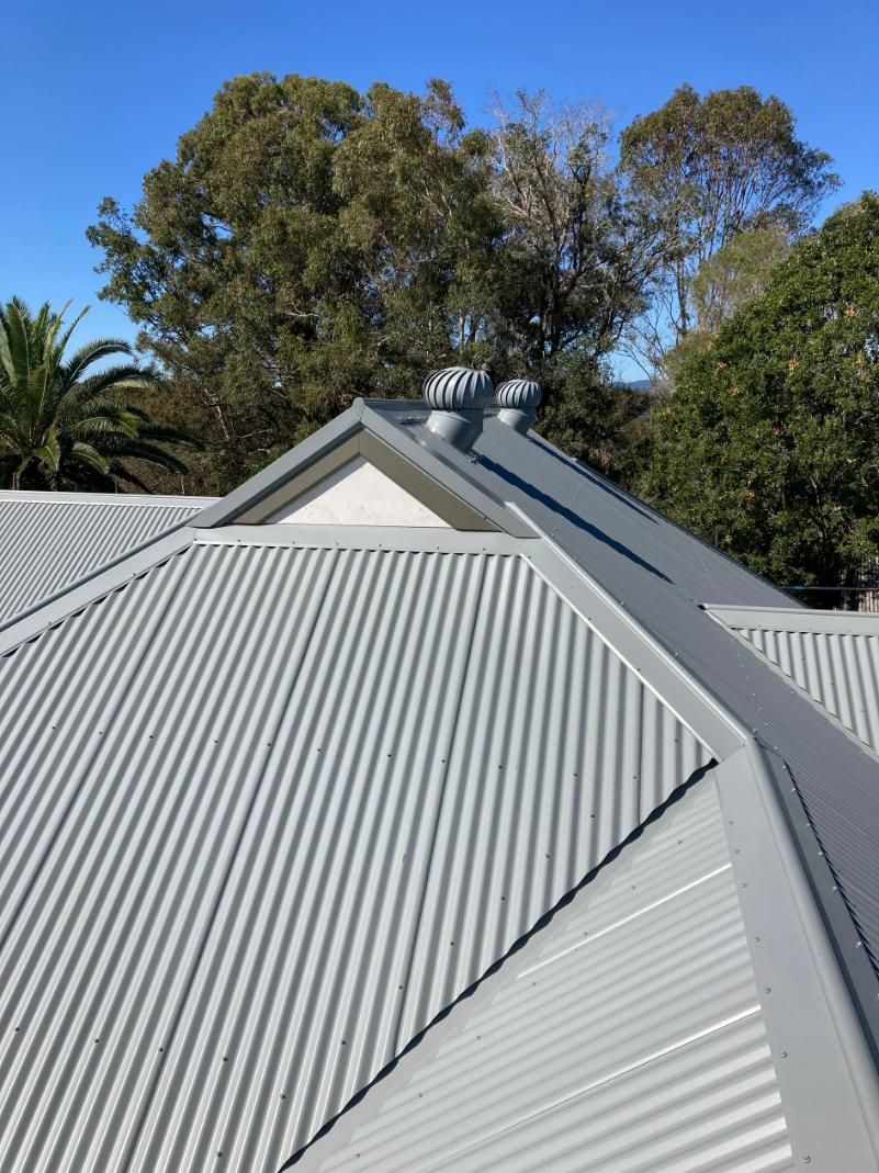 A Close Up Of A Roof Of A House With Trees In The Background — Glenroofing Pty Ltd In Taree, NSW