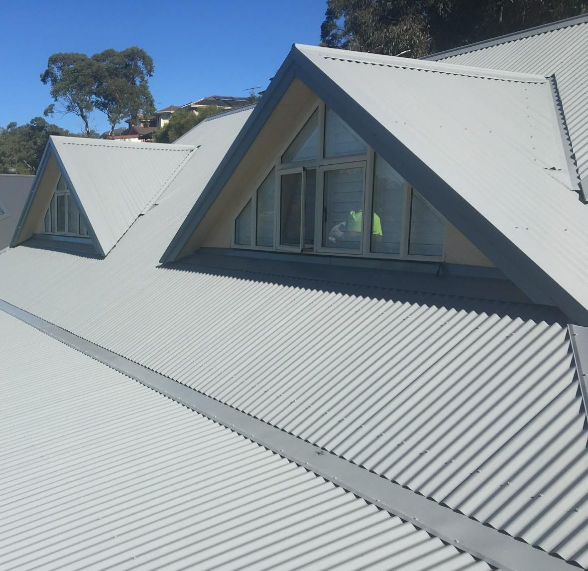 A White Roof With A Triangle Shaped Window — Glenroofing Pty Ltd In Taree, NSW