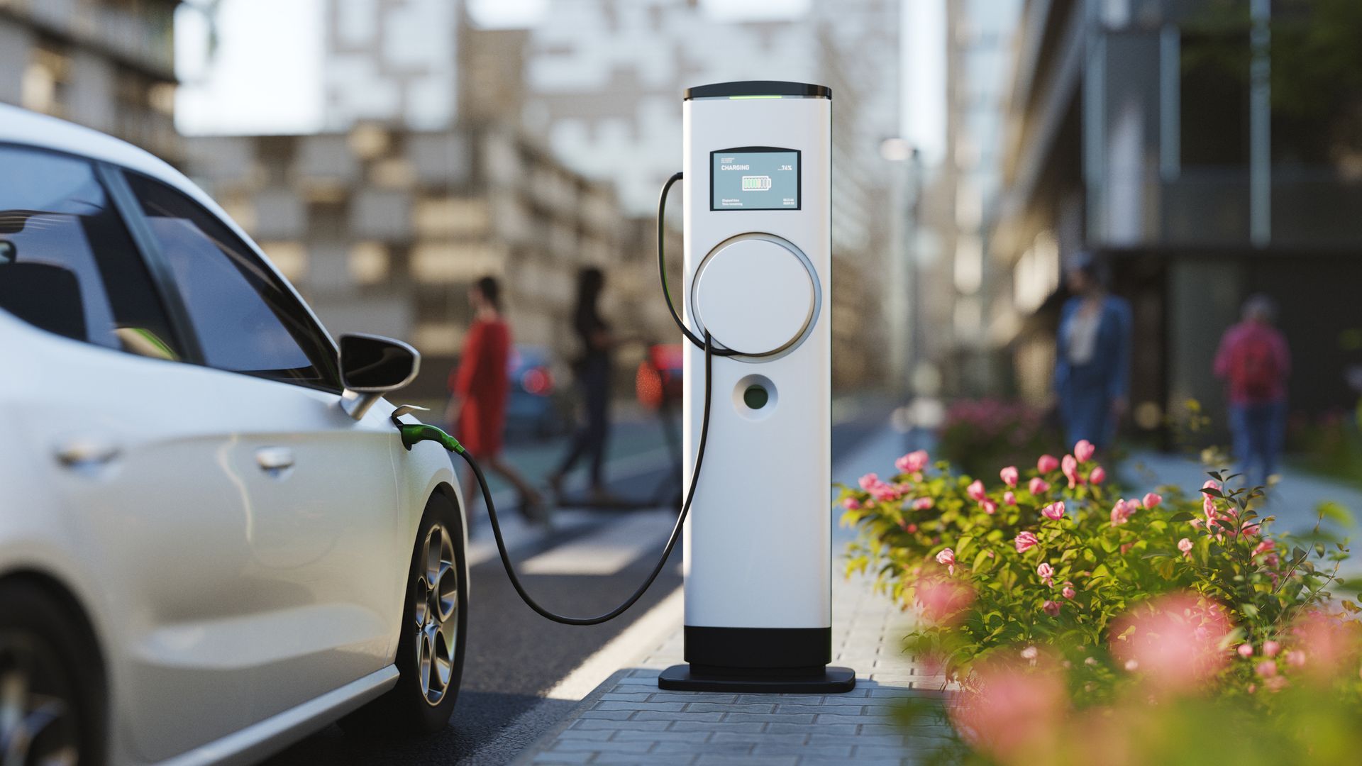 A white electric car is being charged at a charging station.