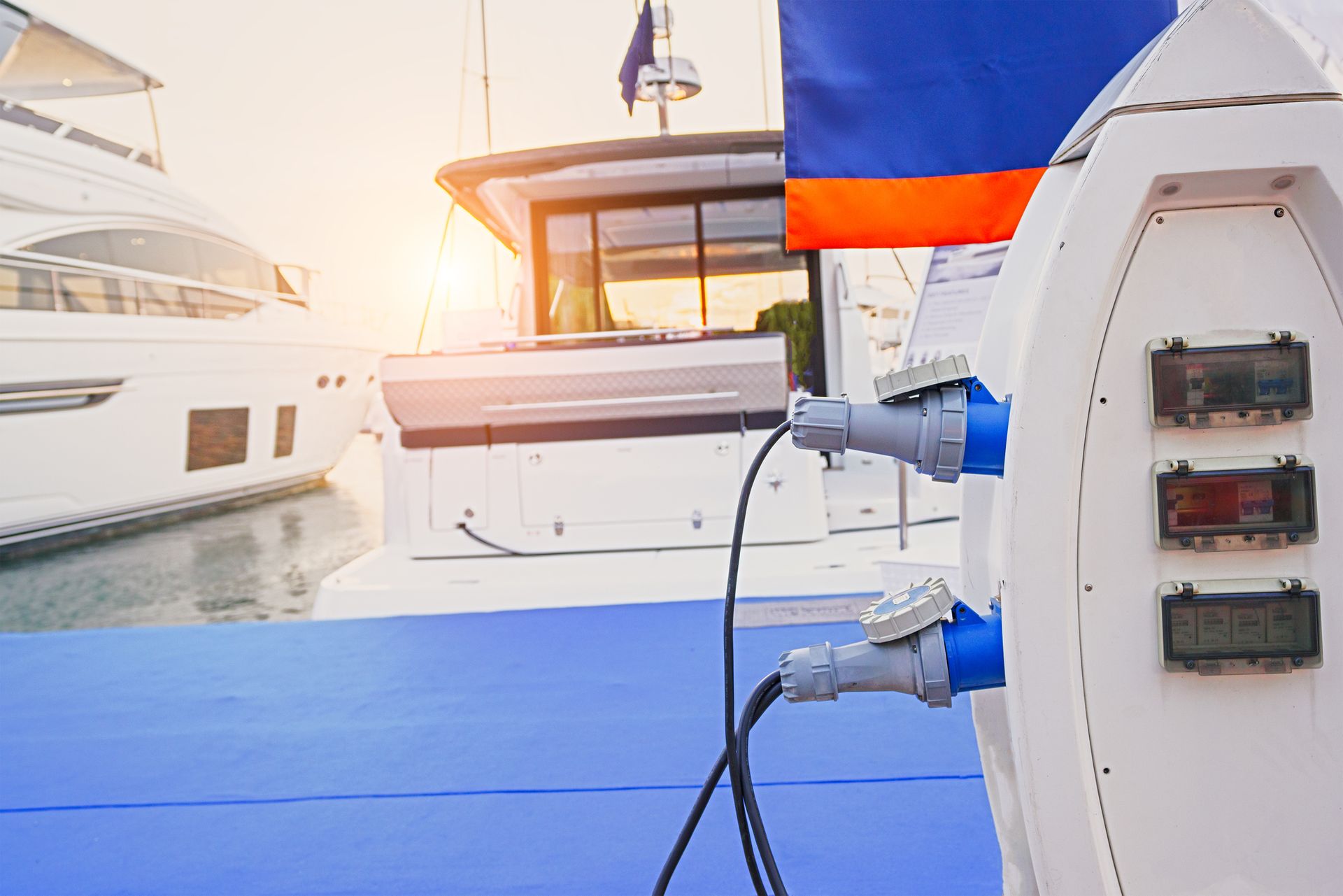 A man is kneeling on the floor in a room with a chandelier hanging from the ceiling.