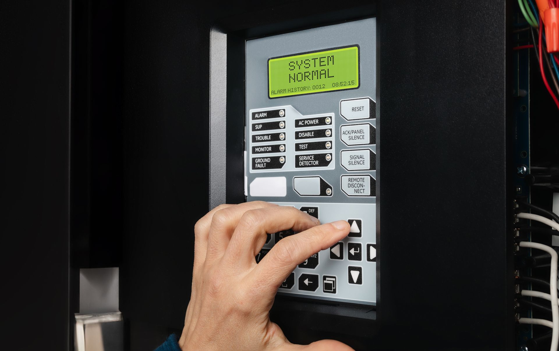 A person is pressing a button on a security system.