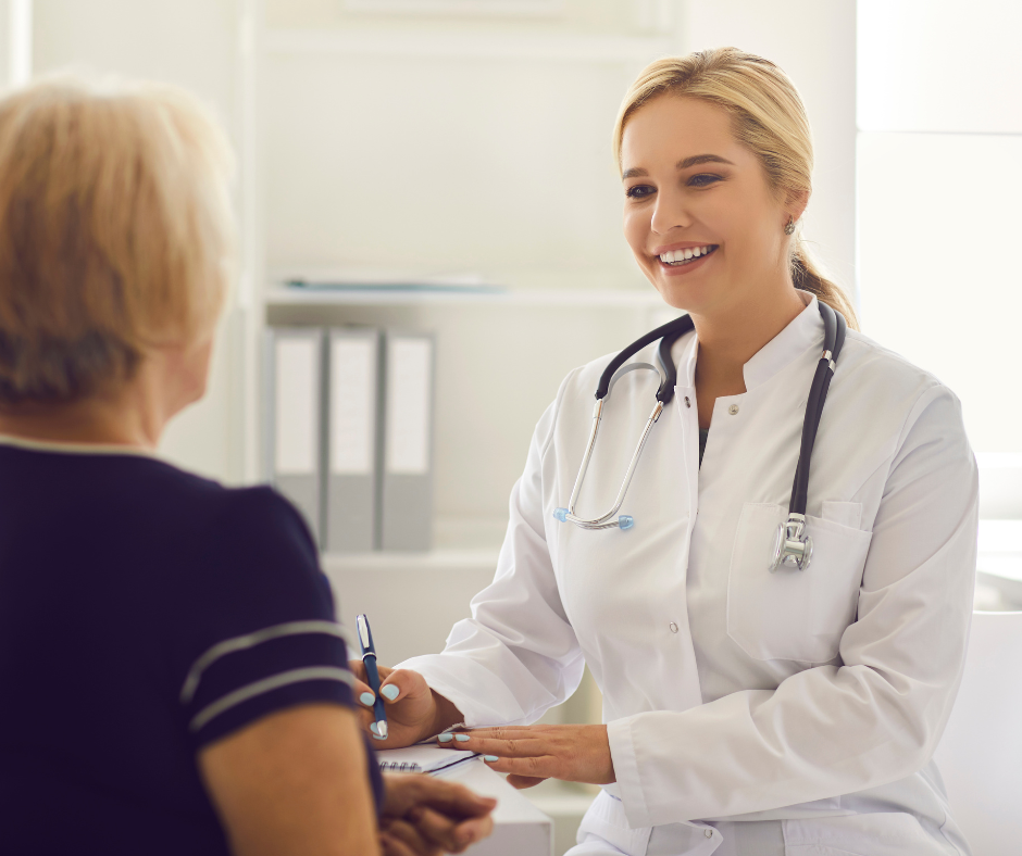 A female doctor is talking to a patient in a hospital.