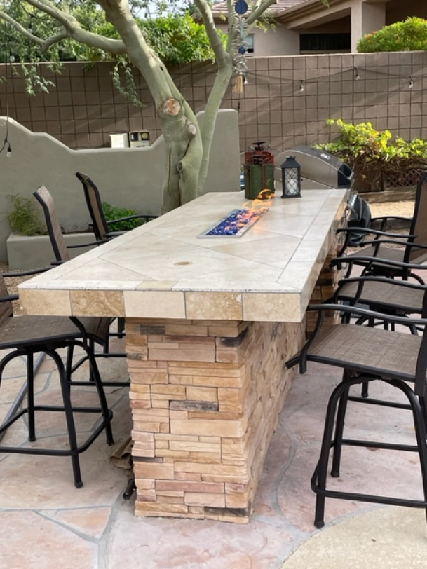 A table with a fire pit in the middle of it