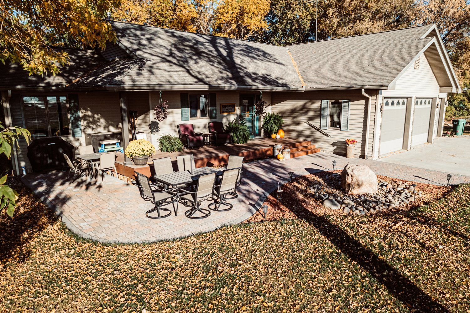 An aerial view of a house with a patio and a fire pit.