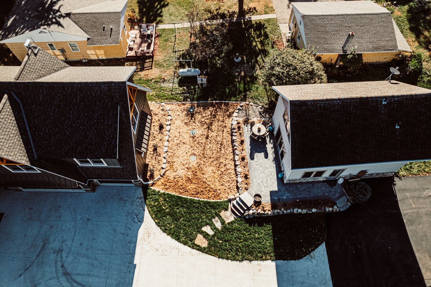 An aerial view of a residential area with houses and a driveway