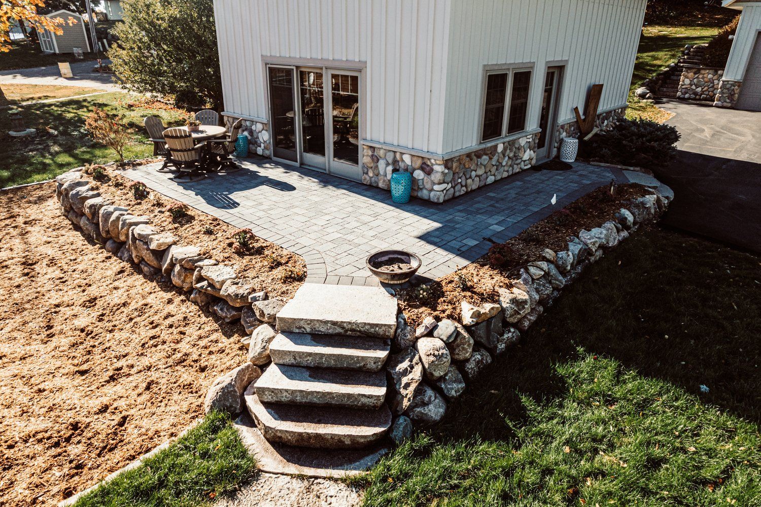 An aerial view of a house with a patio and stairs leading to it.