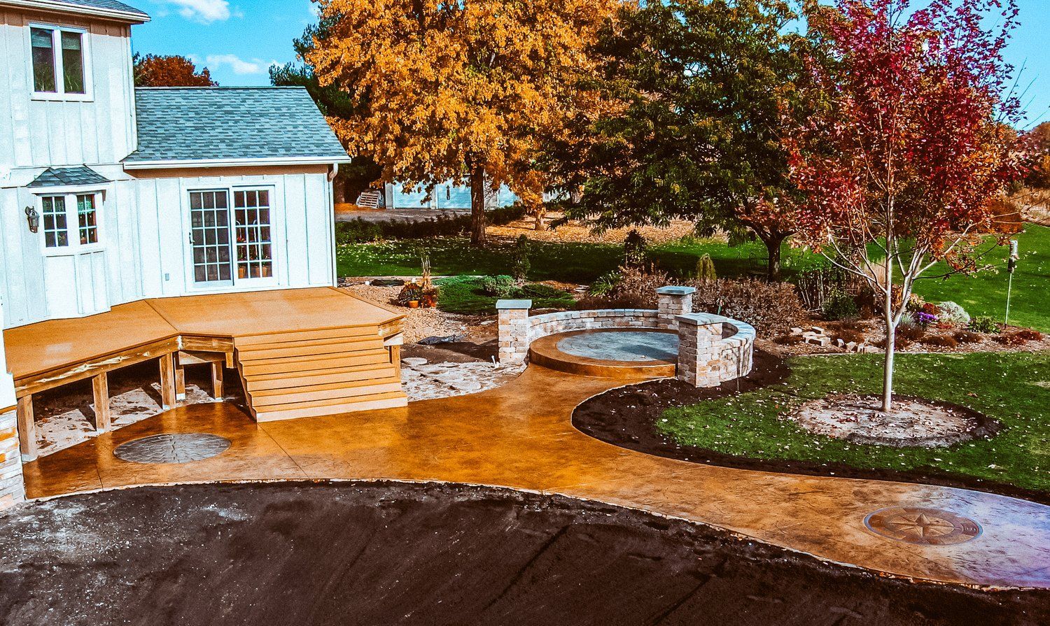 A house with a patio and a hot tub in front of it.