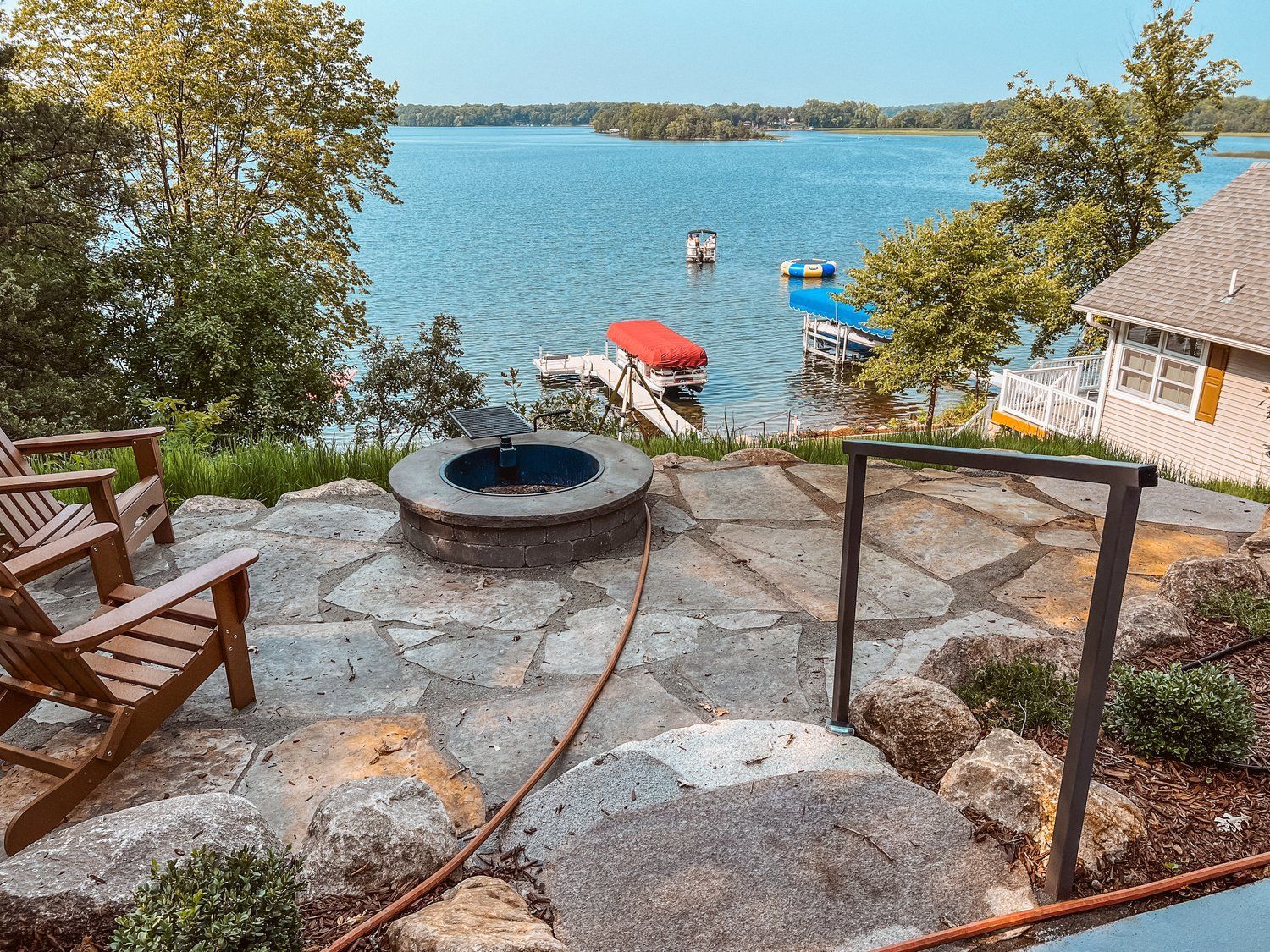 There is a fire pit on the patio with a view of the lake.