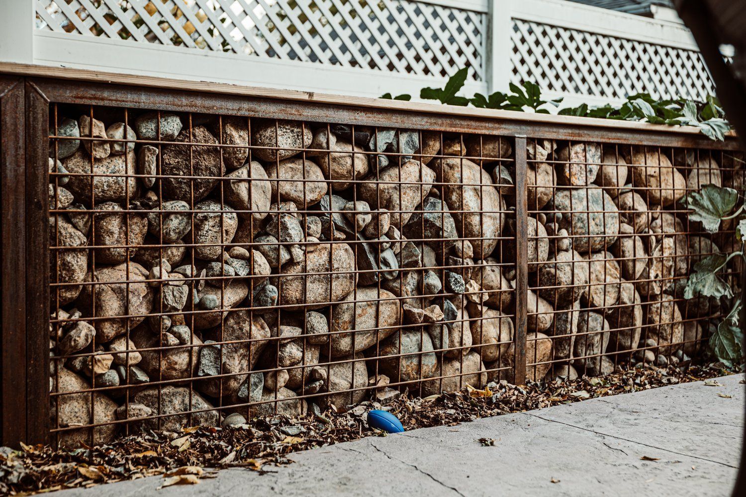 A pile of rocks sitting on top of a metal fence.