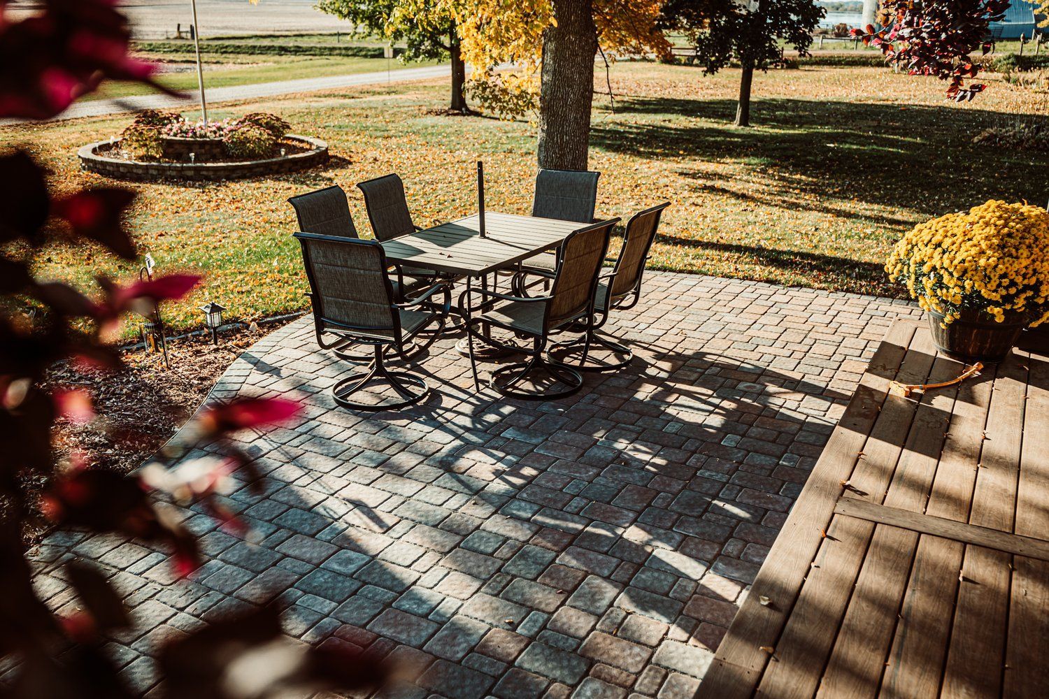 There is a patio with a table and chairs on it.
