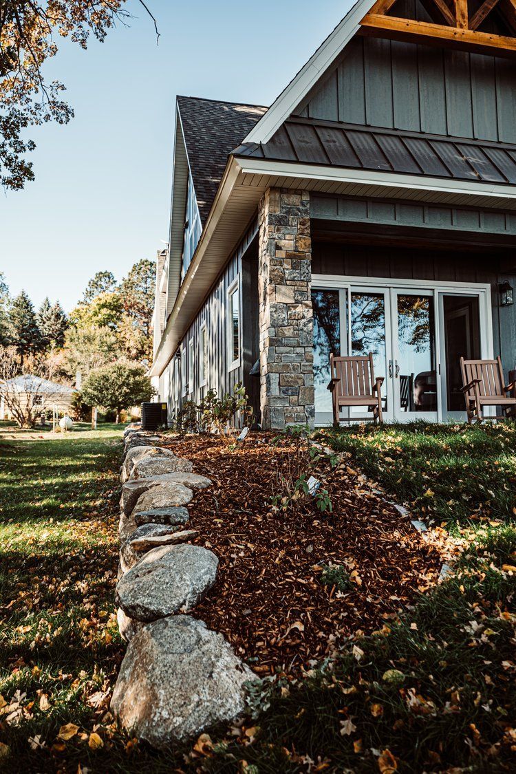A large house with a lot of windows and chairs in front of it.