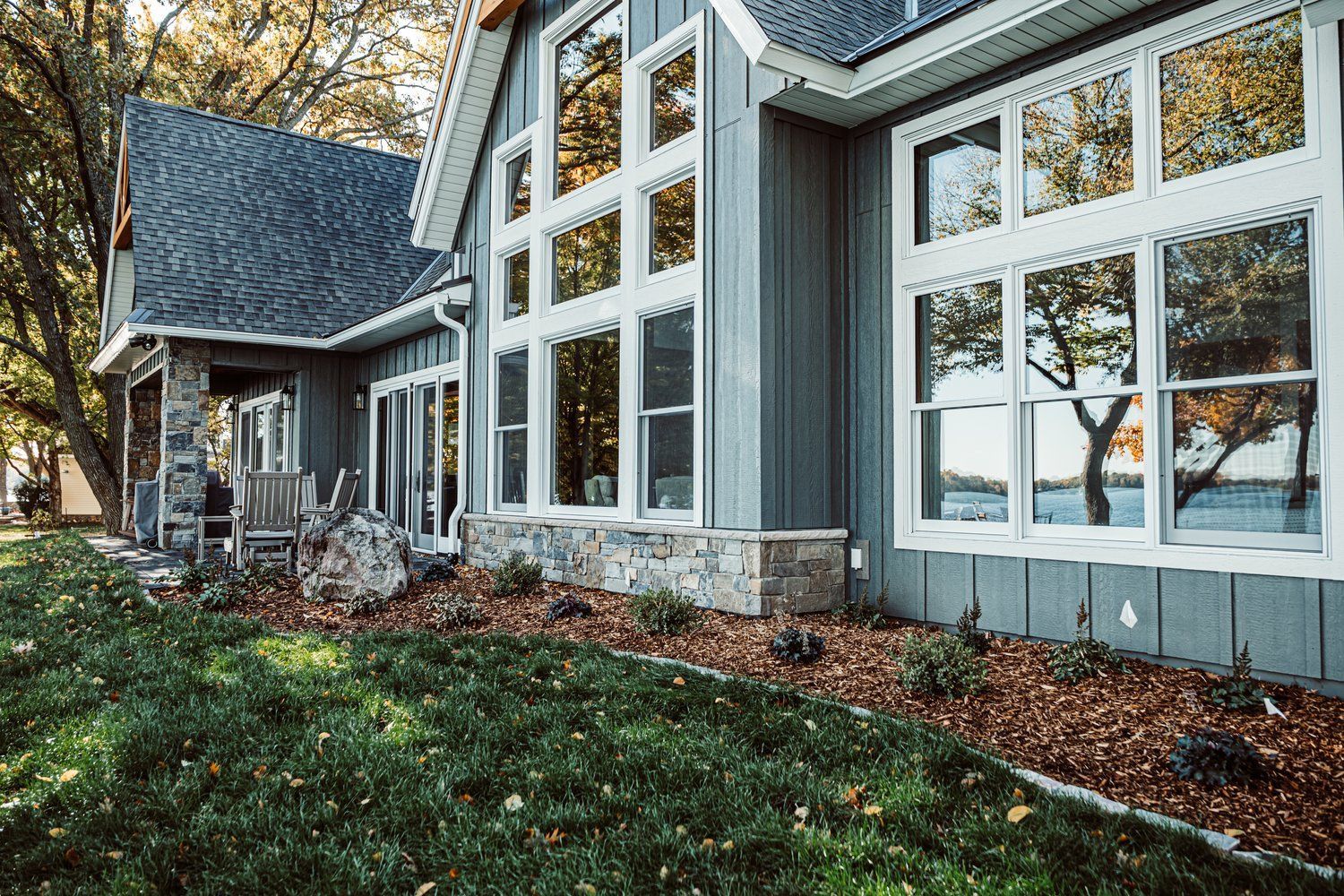 A large house with a lot of windows on the side of it.