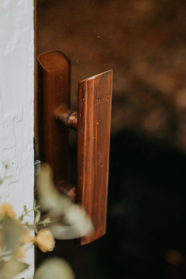 A close up of a wooden handle on a door.