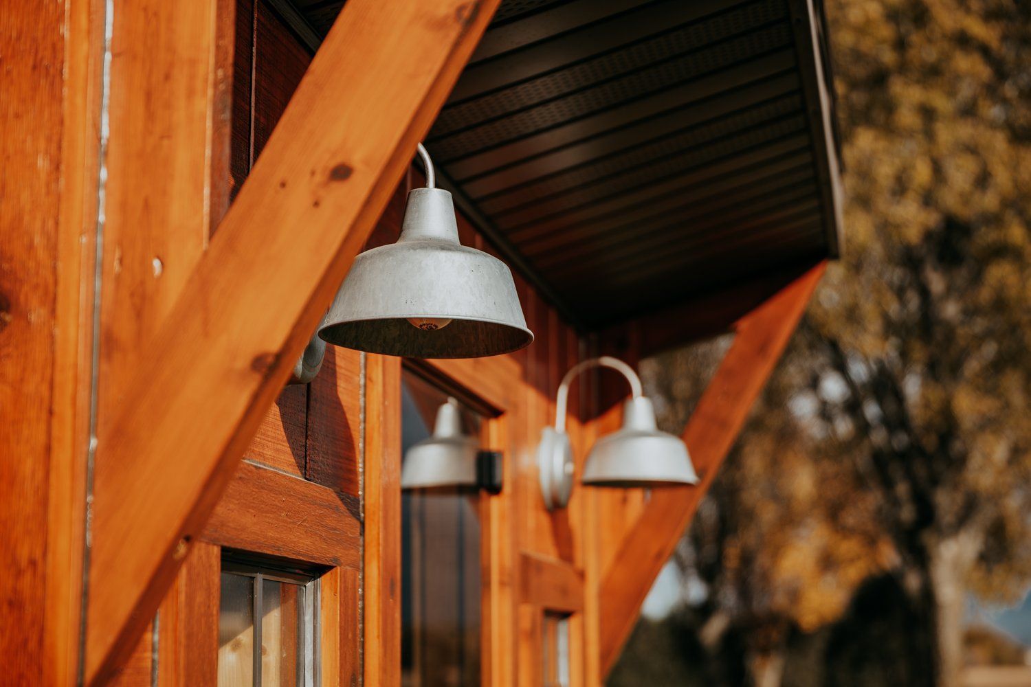 A row of lights hanging from the side of a wooden building.