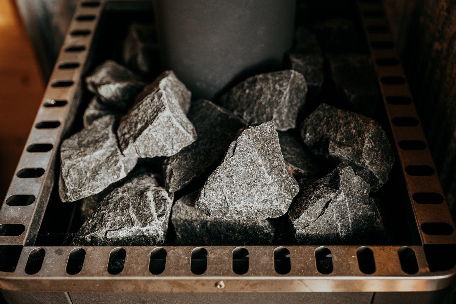 A close up of a sauna with rocks in it.