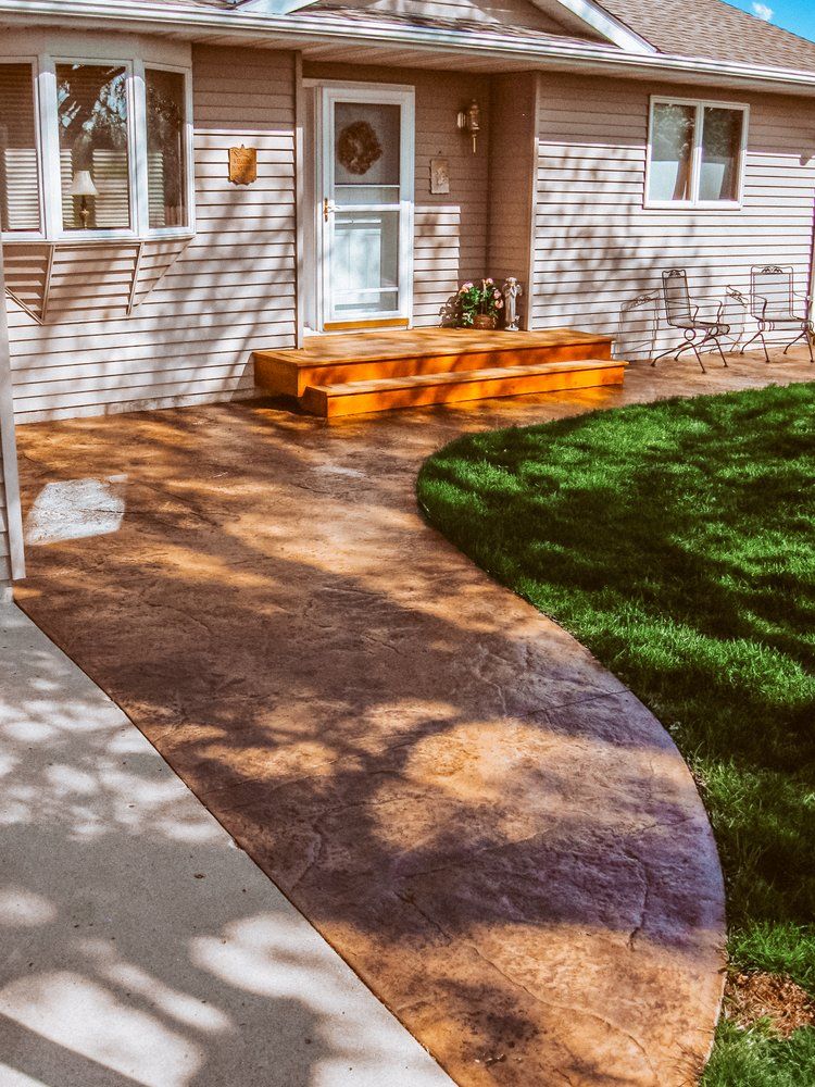 A house with a concrete walkway leading to the front door